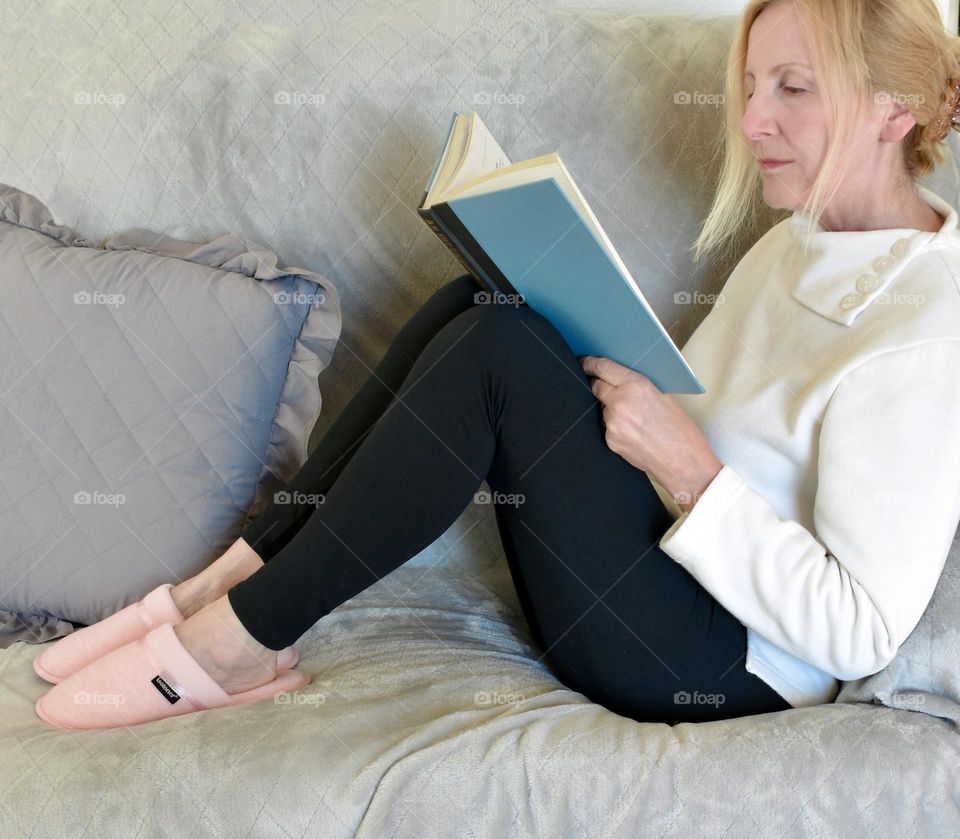 Woman sitting on the couch reading 