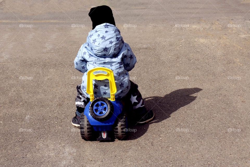 boy riding a car