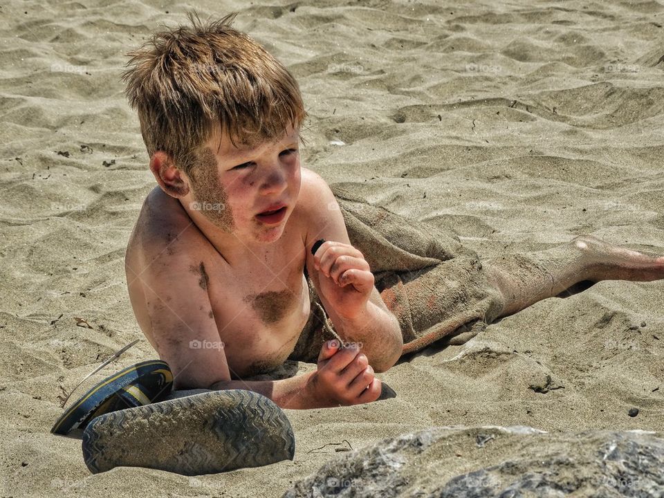 Quite Sandy And Dirty Beach Boy. Boy Coveted In Sand