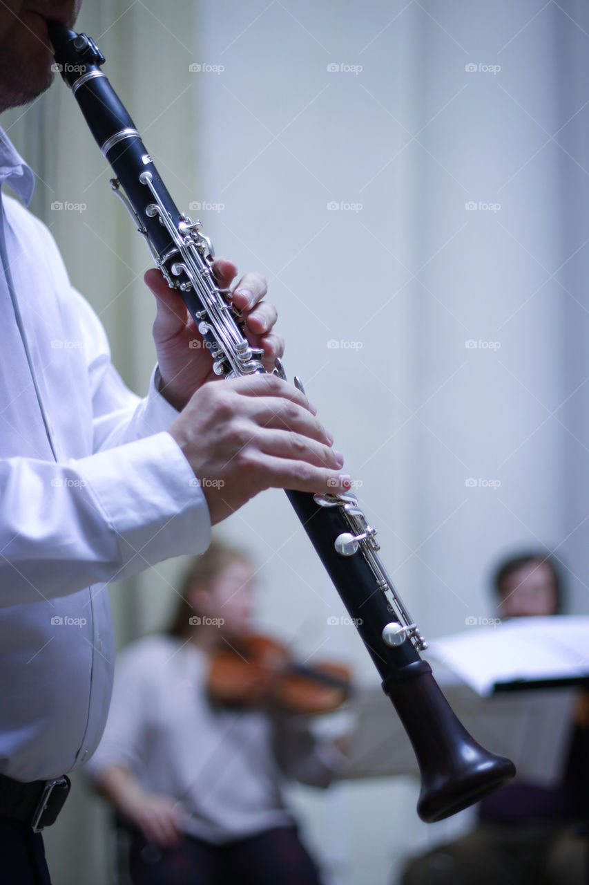 The musician plays the clarinet at a concert of classical music.  Hands of a musician.  Valves