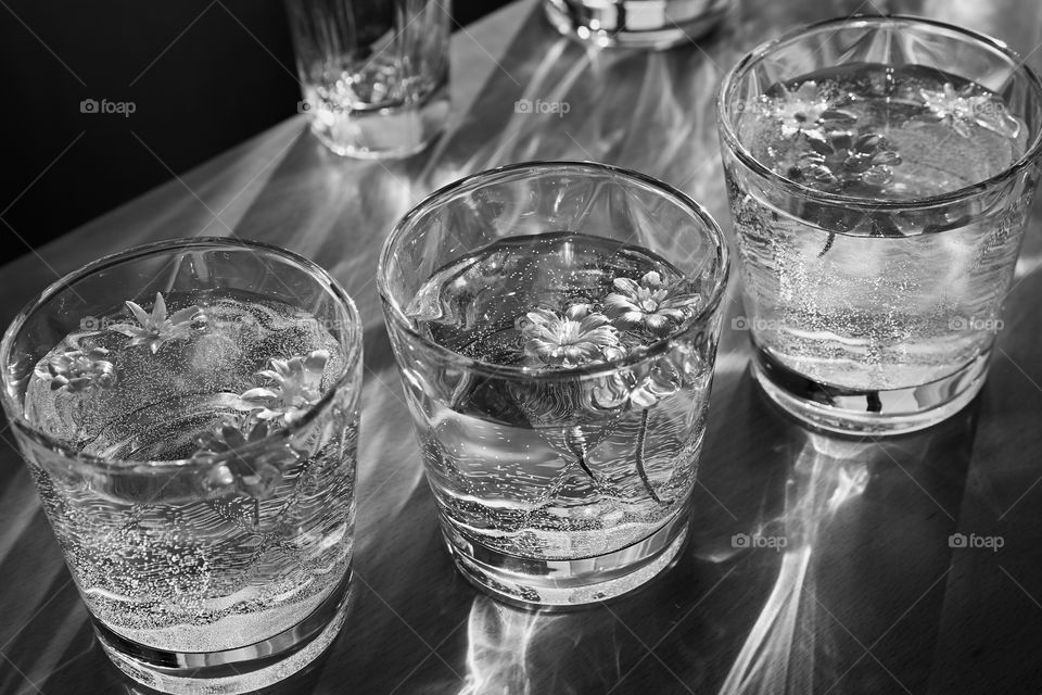 Glass vessels with water and floating flowers.