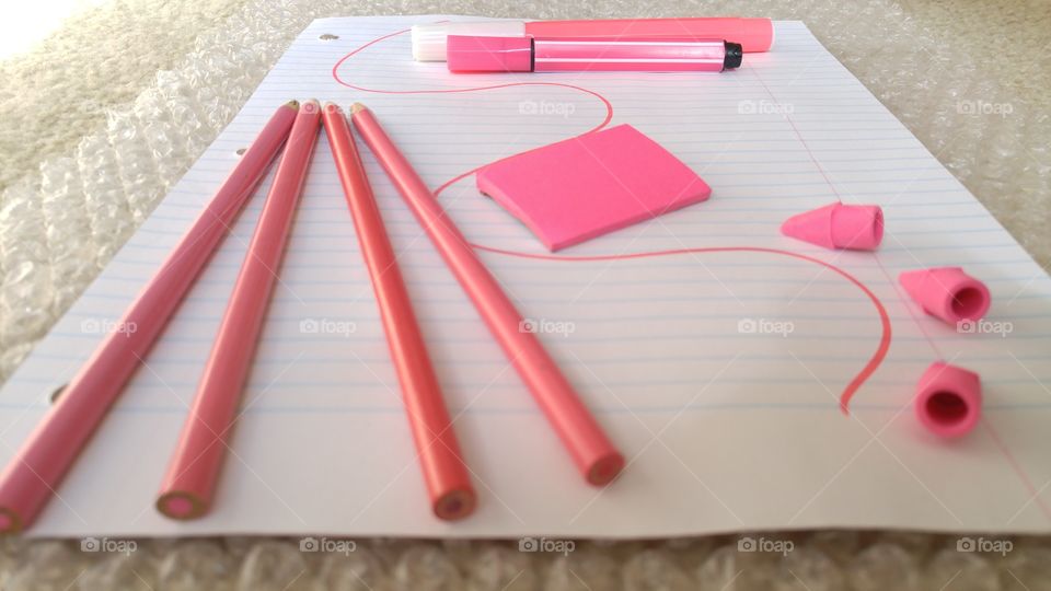 Lined paper with pencils and eraser