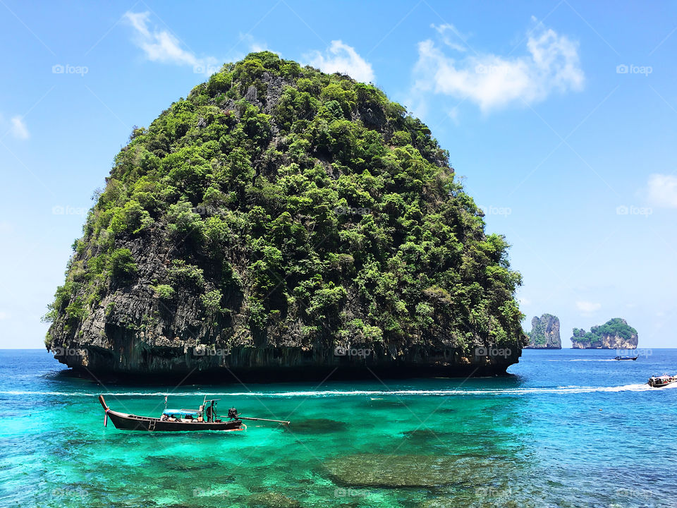 Enjoying the last summer days swimming in boat along the tropical island 