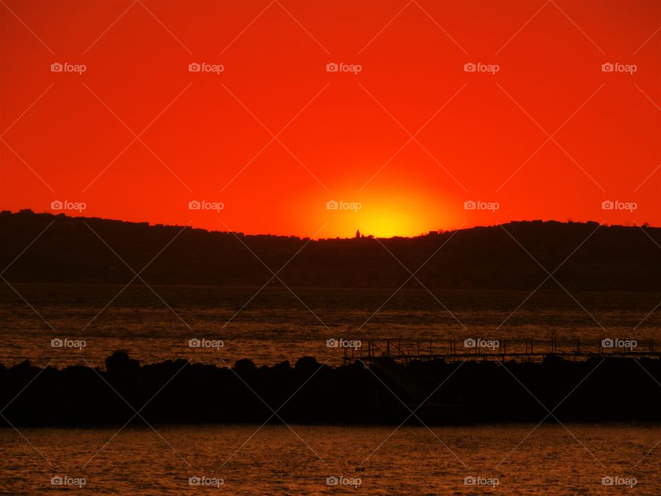 Sun goes down behind the Bacoli hill (Naples - Italy ).