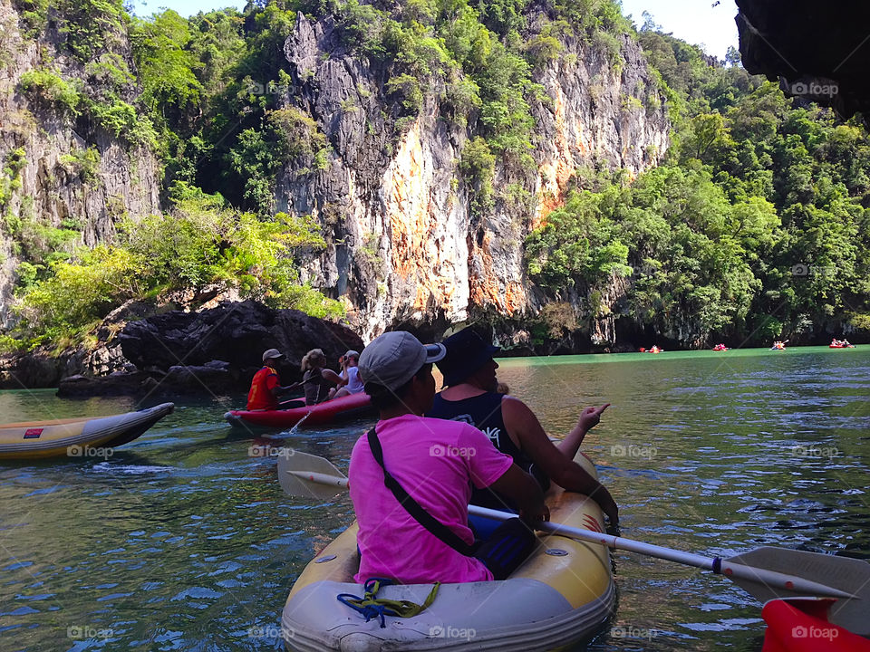 Travel in boat near the rocks 