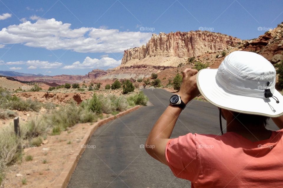 A man taking a picture of beautiful scenery, Utah 