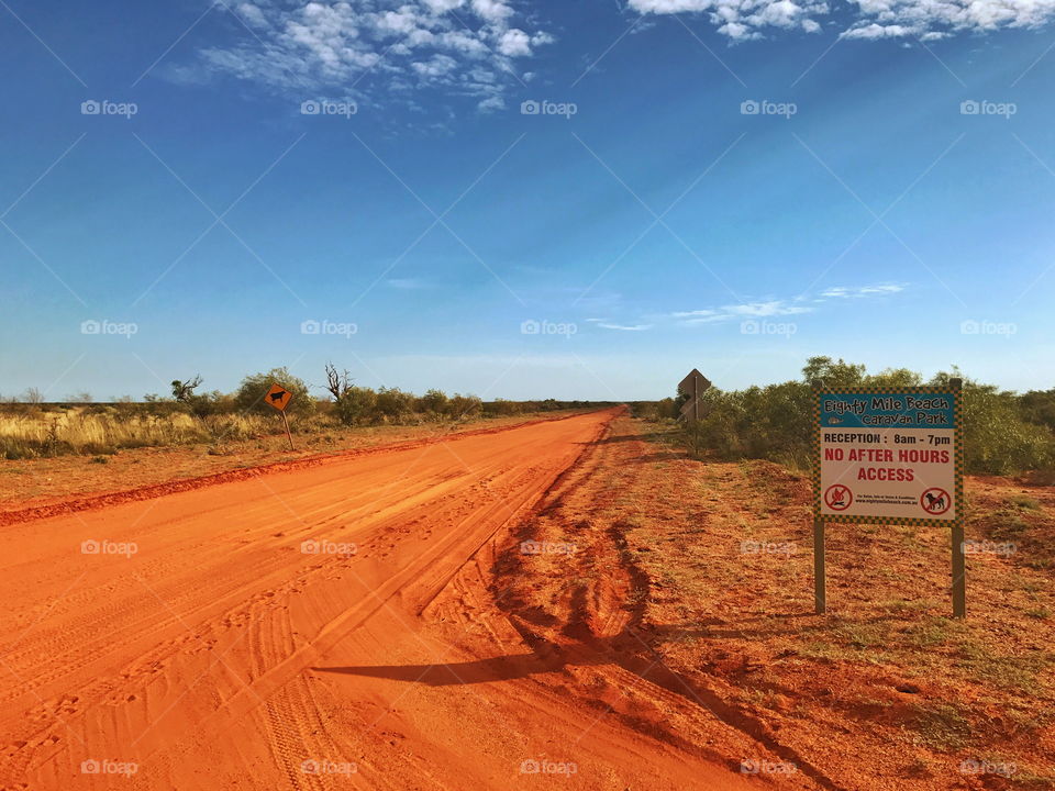 Red dirt road leading to eighty mile beach