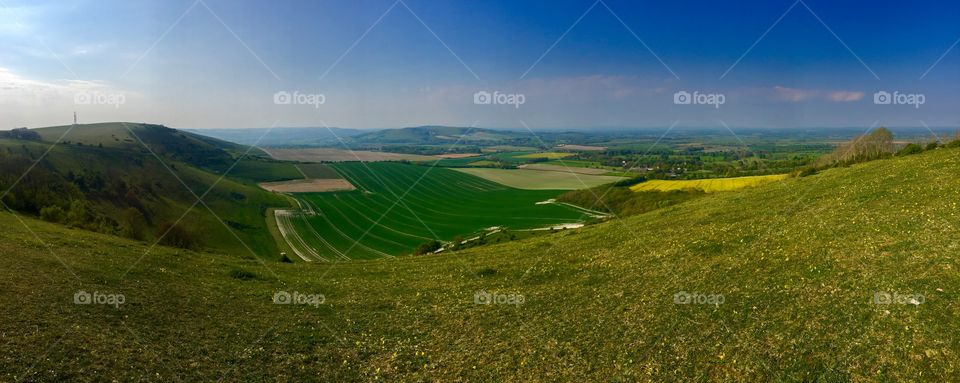 Panoramic rolling hills on the South Downs with blue sky