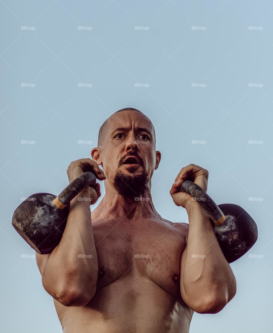 Man with kettlebells.