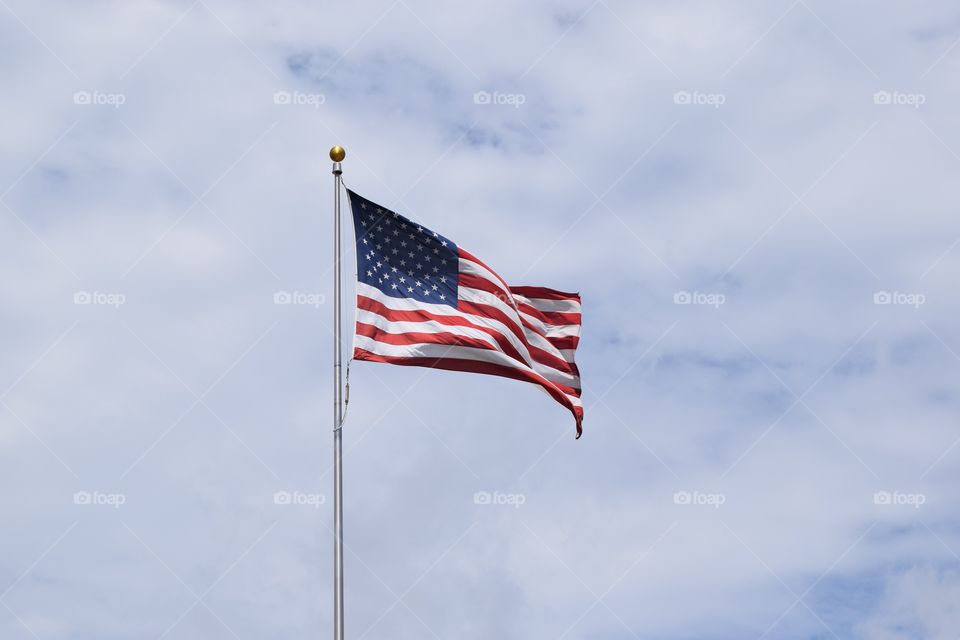 Low angle view of american flag against sky