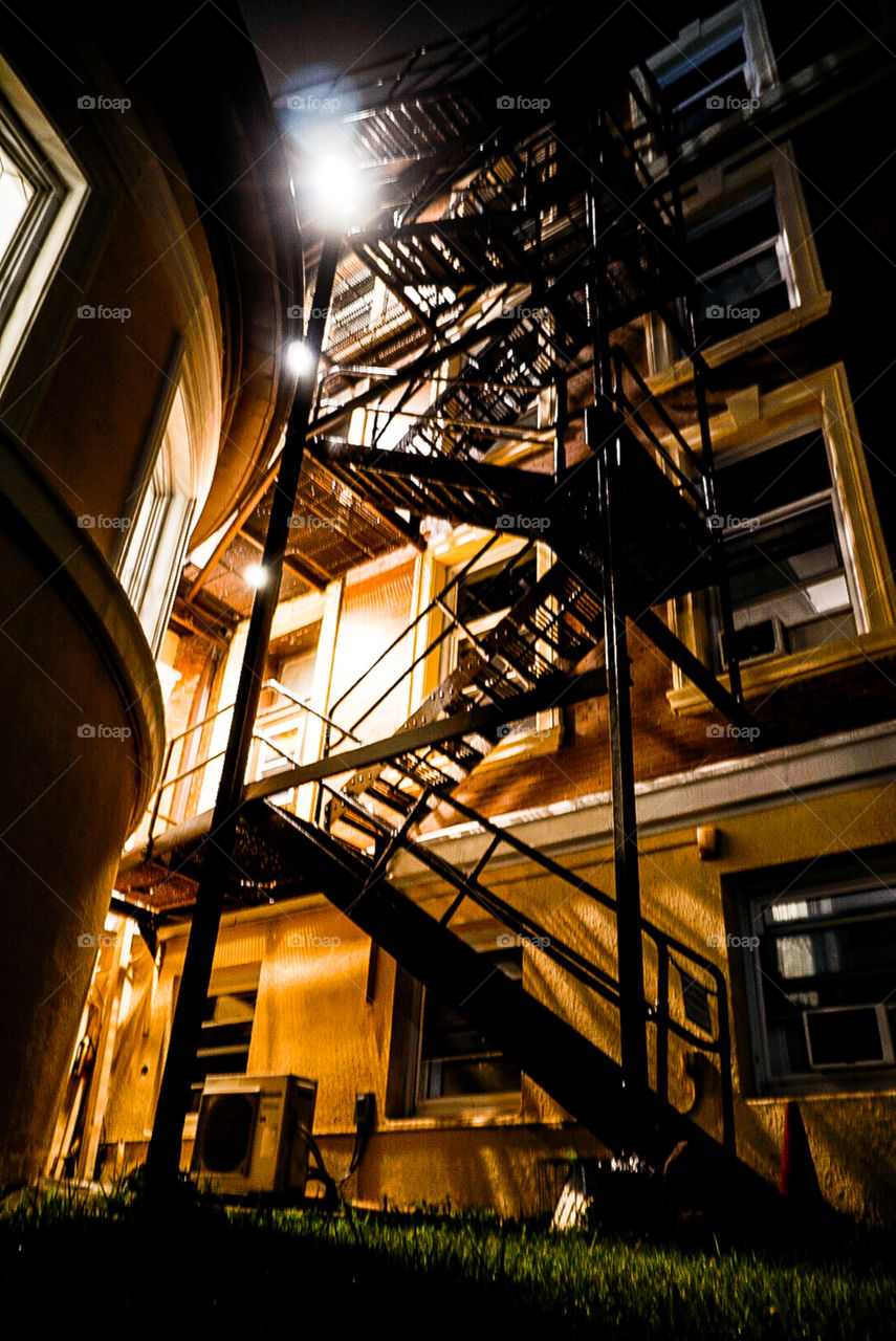 Metal staircase ascending into a wonderous building.