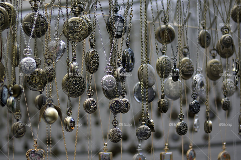Close-up of hanging pocket watch on chains