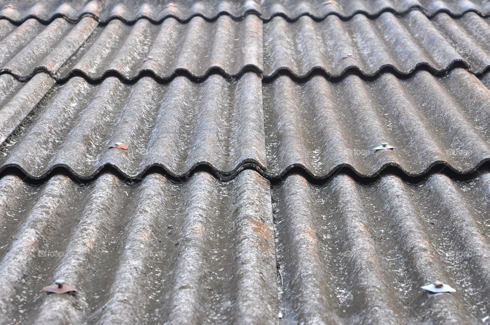 Old gray roof tiles texture. Corrugated roof tiles.