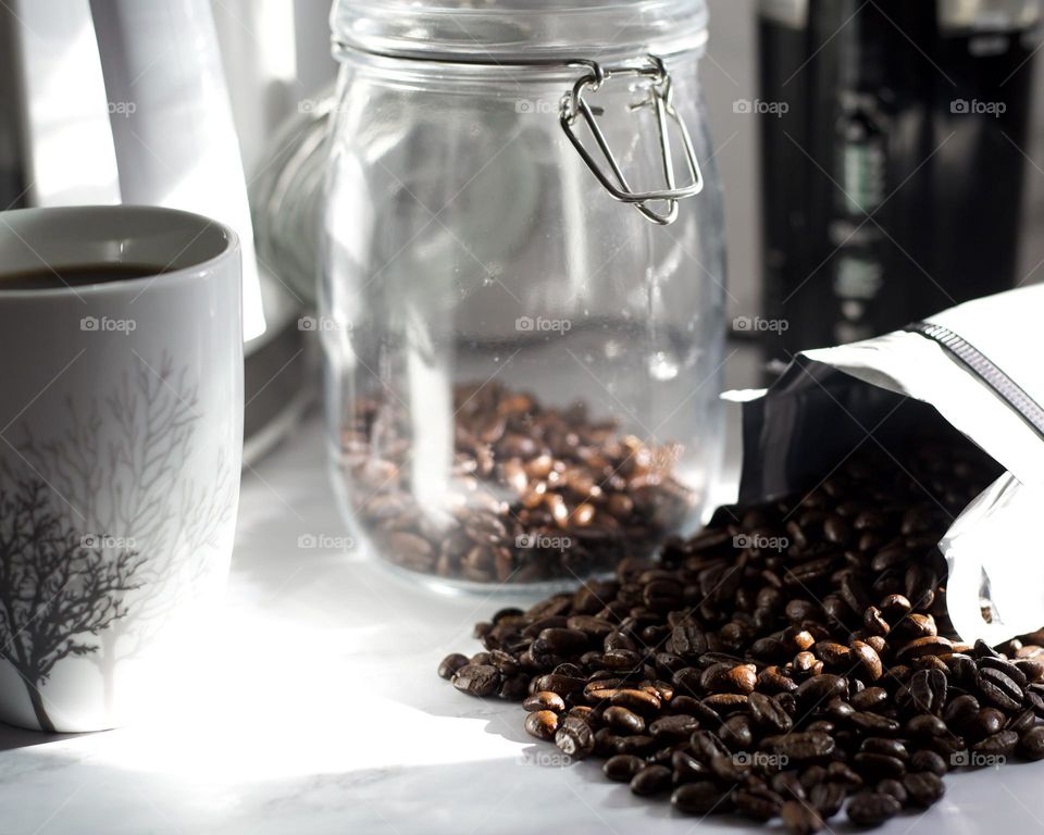 Coffee beans, jar, and a coffee cup