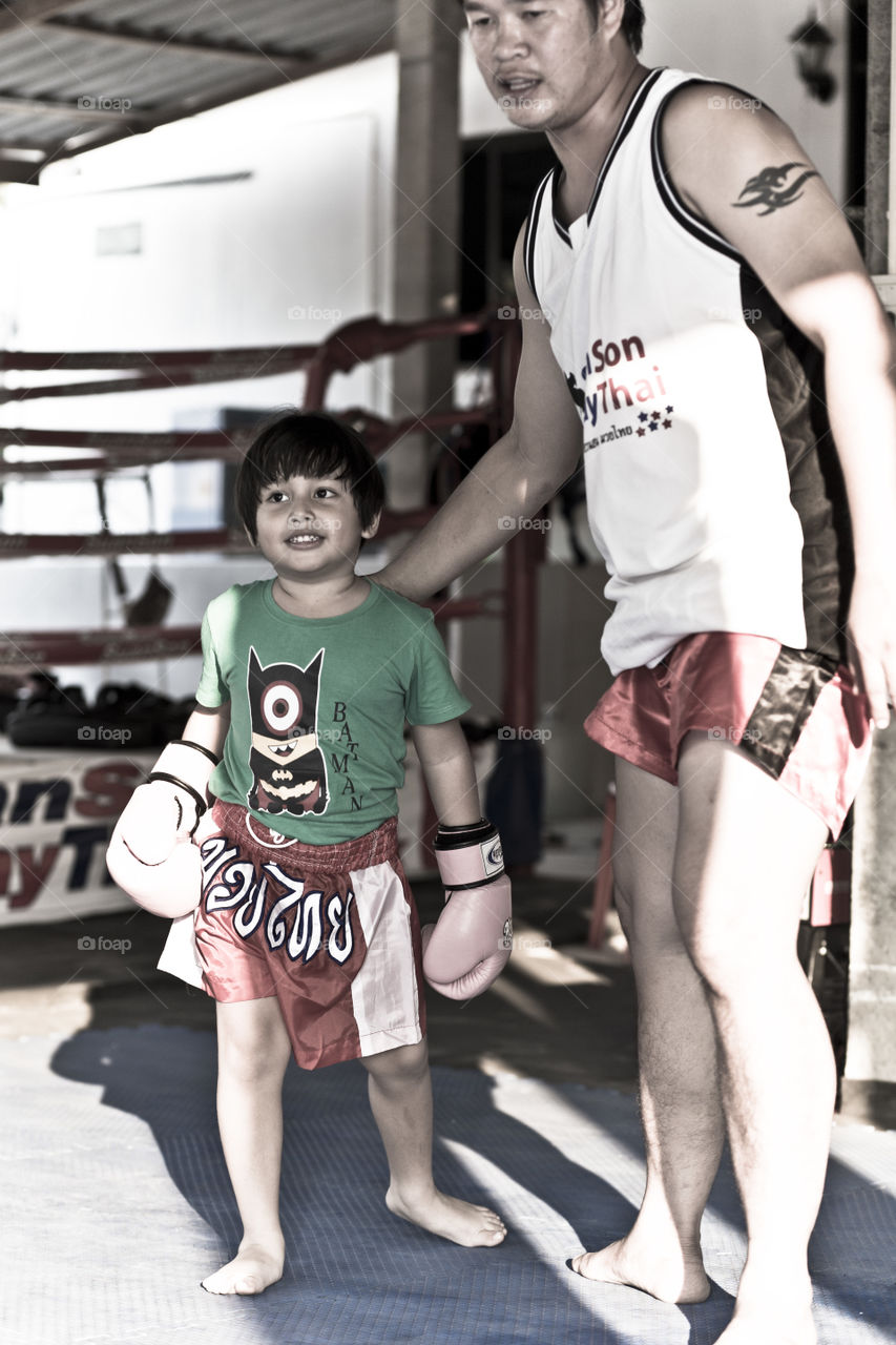 young boy fighter with his coach . model Thitiwin Dupont 