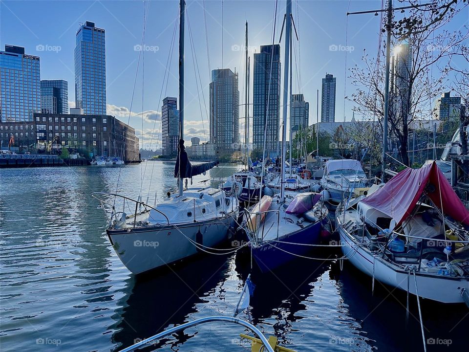 This is „Newtown Creek“ by the „Pulaski Bridge“ in LIC, Queens with its various boats. It is especially charming at twilight time just before nightfall when the „East River“ shimmers in shades of bright silver to blue. 2024. Hypnotic Productions