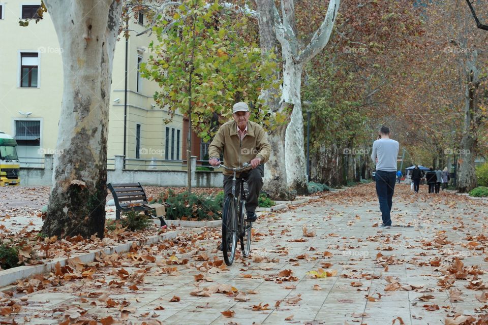 Senior man on cycle ride in the park