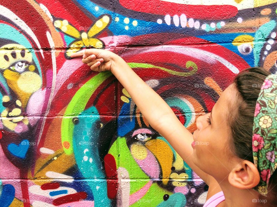 Child in front of a colorful wall