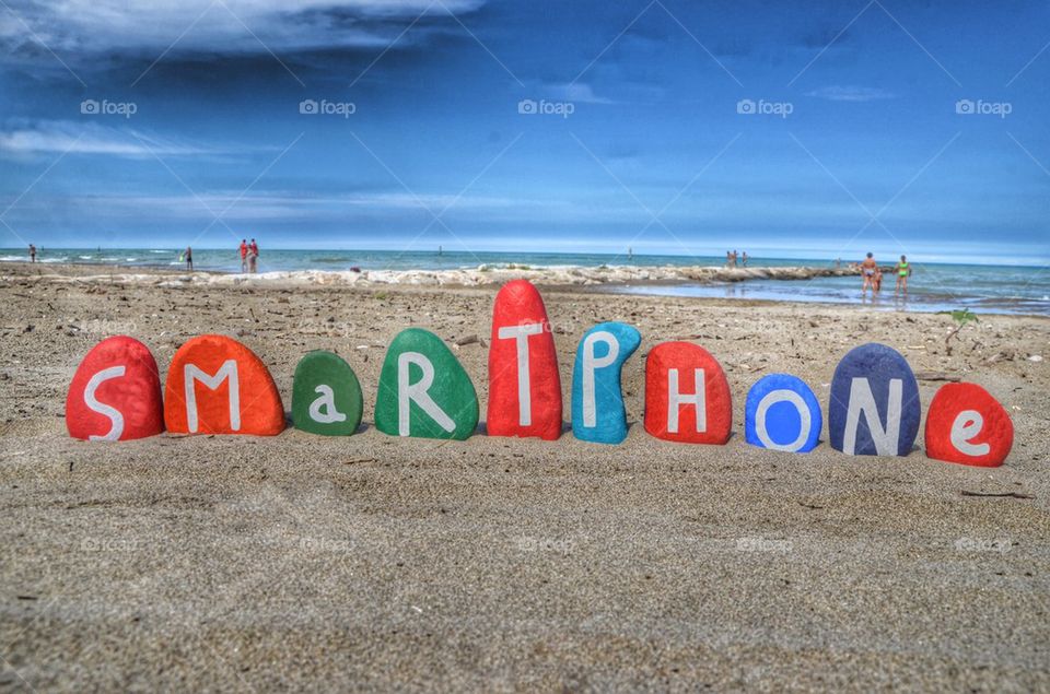 Smartphone concept on colored stone letters