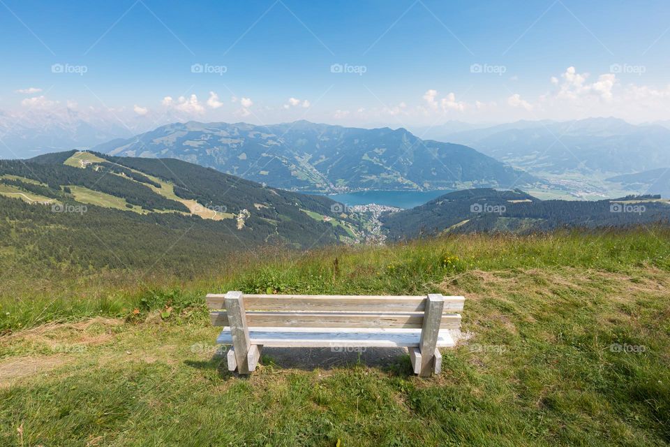 Bench on mountain Schmittenhöhe Austria with a beautiful panoramic view of lake Zell am see and mountains 