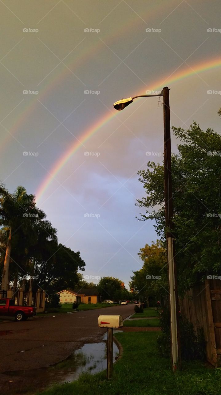 Street with rainbow in sky