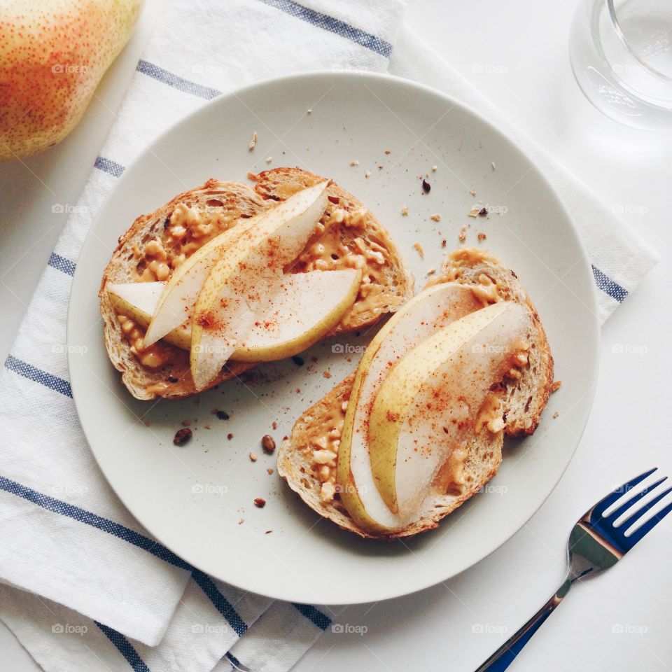 Warm up flat lays : Sliced pear with peanut butter toasts.