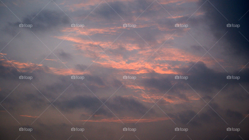 The misty clouds over the burning Orange sky.