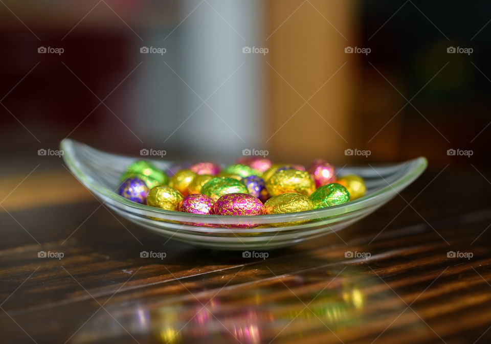 Colorful chocolate Easter eggs on wooden table