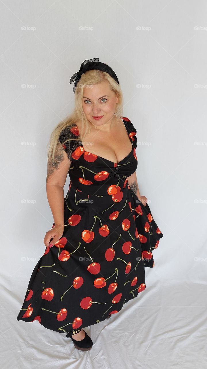 Woman wearing vintage dress with cherries blond hair