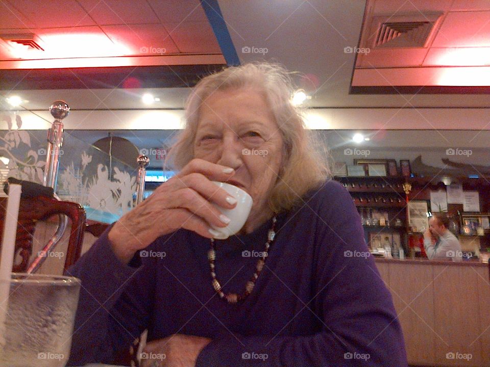 Smiling Elderly Lady Enjoying Tea