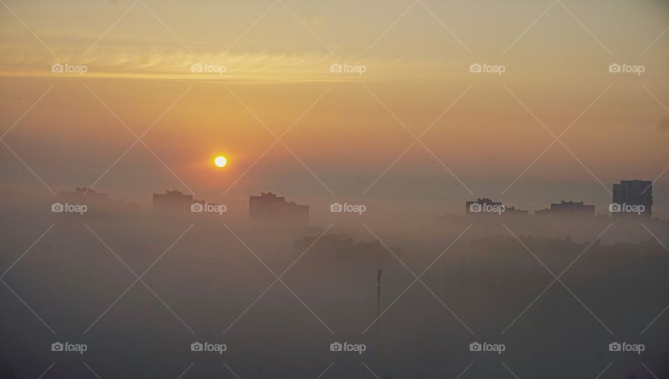 foggy sunrise in the city