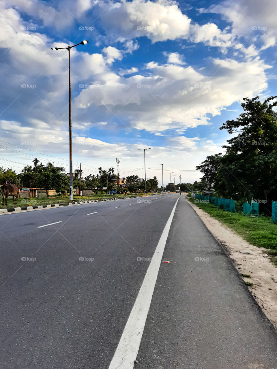 Photo of a national highway in India.. Photo captured after  lockdown... empty road.. less transportation... less vehicle... clear blue sky... clean enviroment...