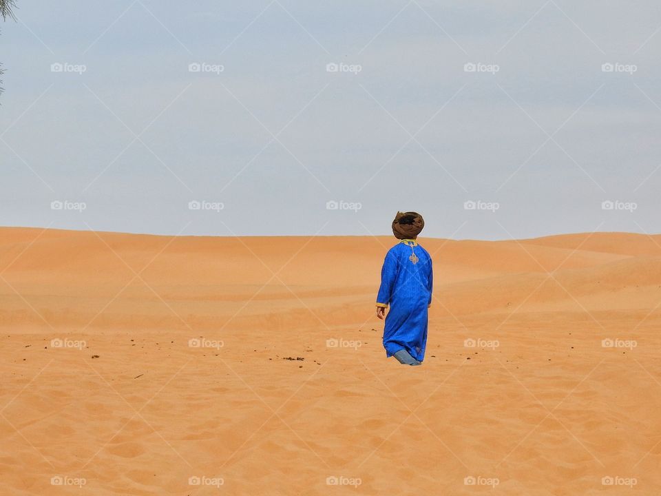 Rear view of person standing on sahara desert