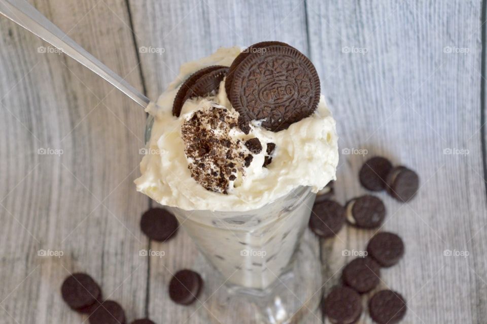 Oreo cookie milkshake with a wooden rustic white background