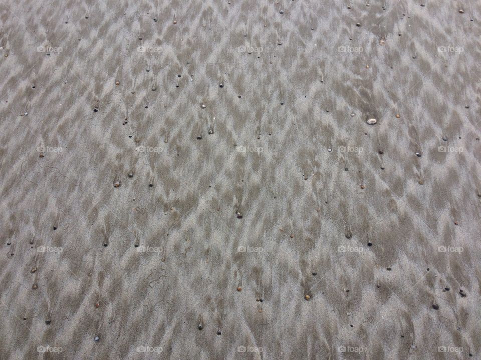 Tidal patterns in the sand on a beach