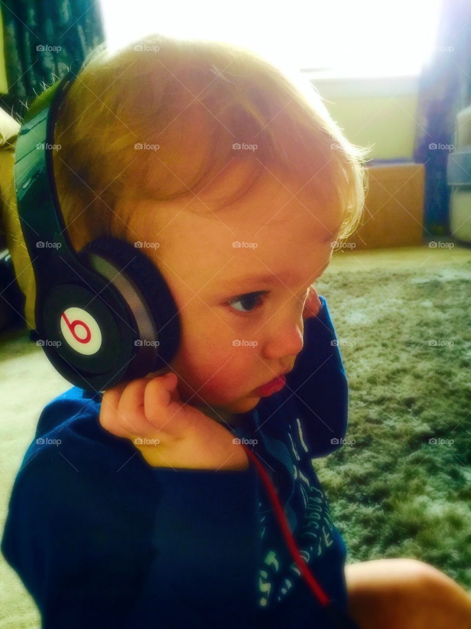 Wee dude. Listening to his favourite tunes