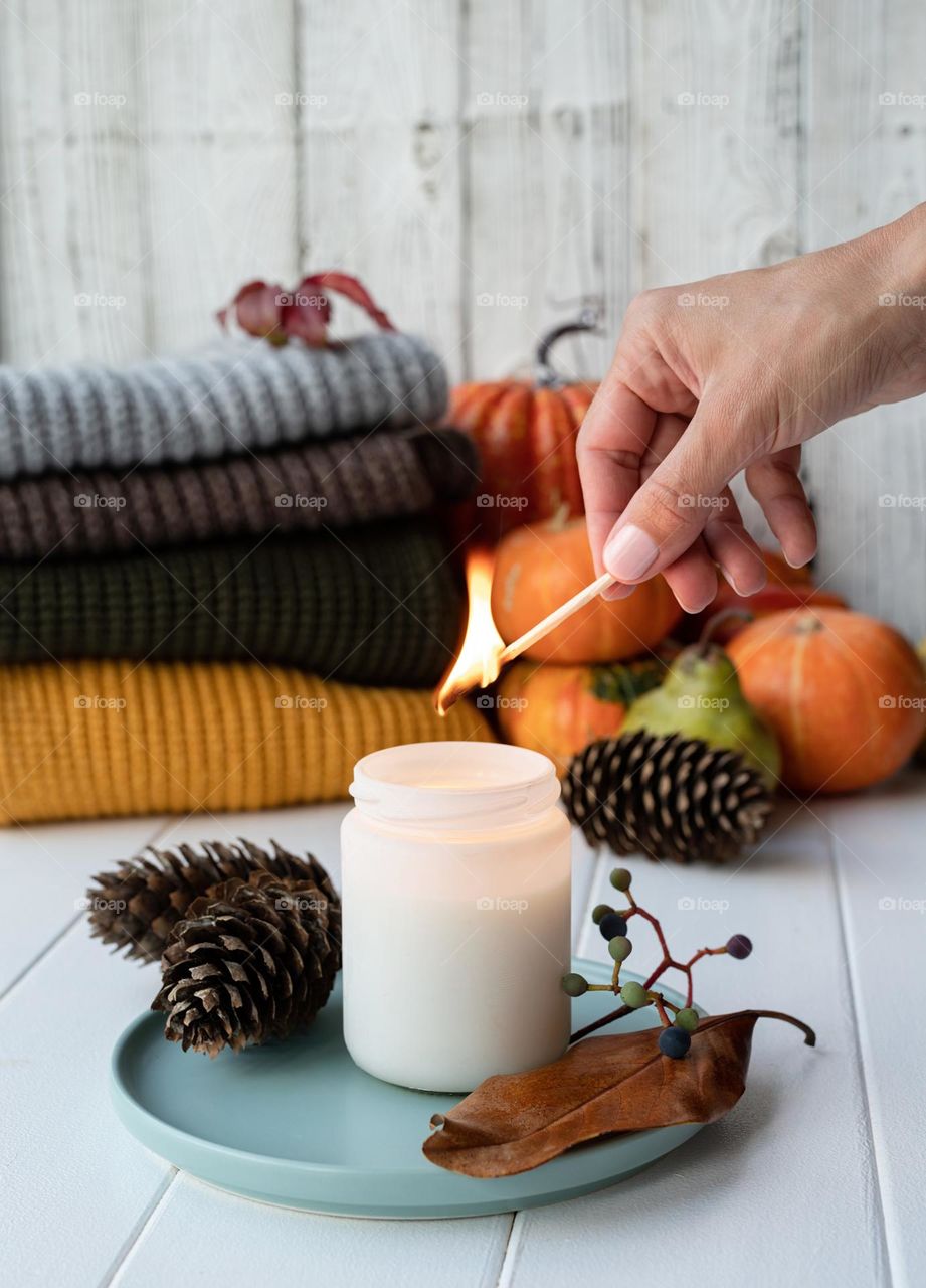 female hand burning candle