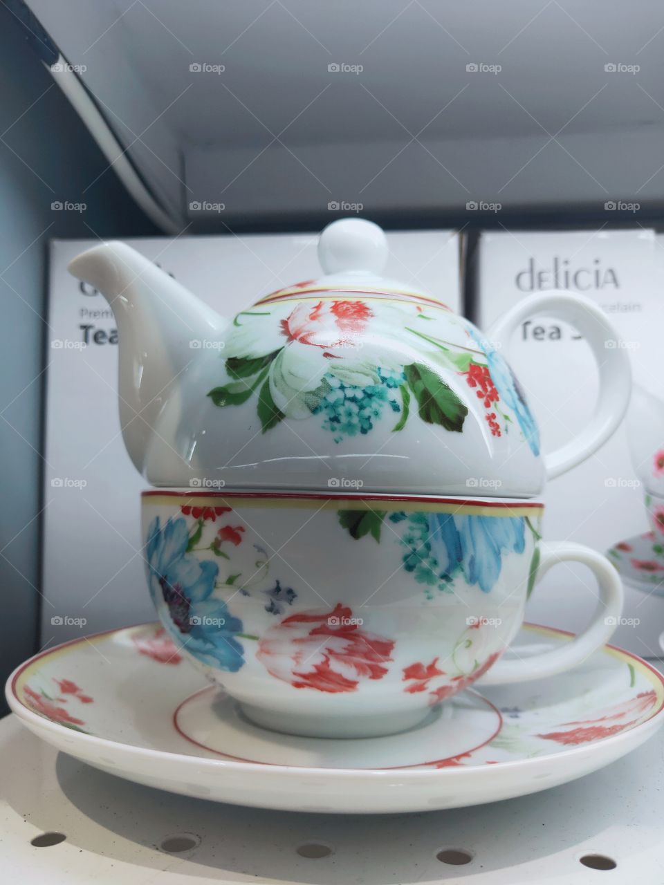 a teapot for drinking water with a very beautiful colorful flower motif. can be found in the market shop