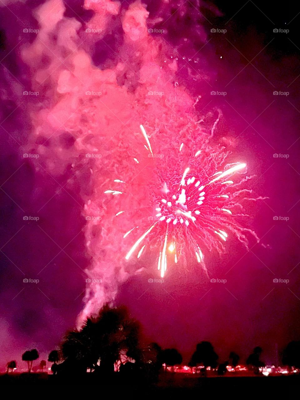 Pink fireworks lighting up the night sky, in the shape of a heart for July 4th at Pirates Beach, Texas. 