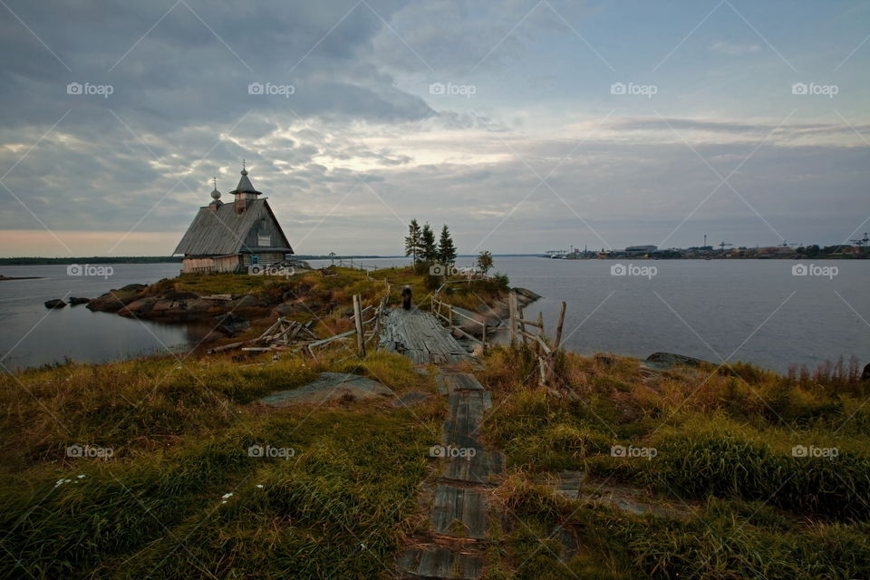 White Sea at early motning. Wooden church in Rabocheostrovsk, Kem, Russia