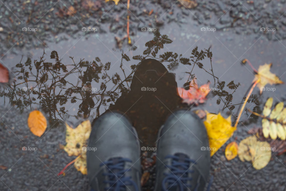 Shoes in a puddle with reflection