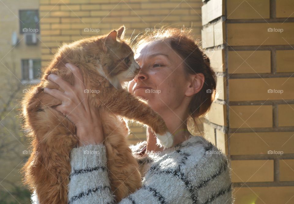 woman and ginger cat family relaxing, love pet