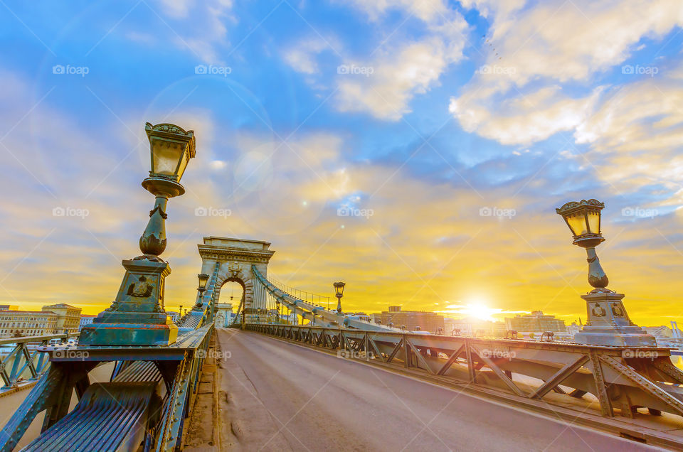 Chain bridge at sunrise with lens flares in Budapest 