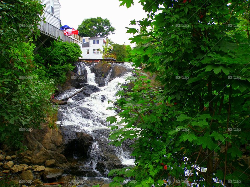 River Under. The waterfalls at Camden, Maine dumping into the harbor.
