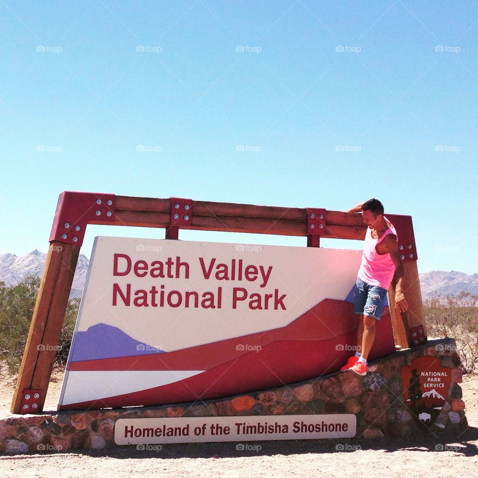 Man on the Death valley sign