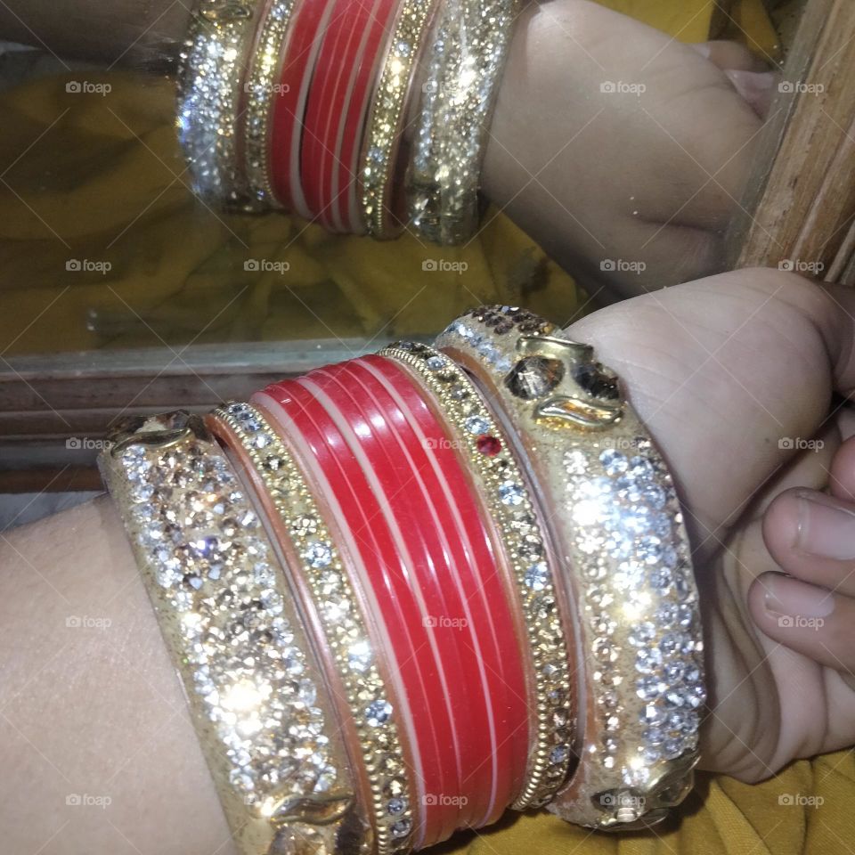 indian women wear bangles in their hands.
