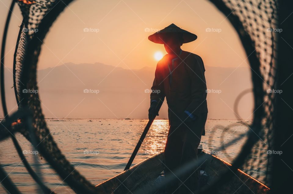 Traditional Burmese fisherman at sunrise on Inle Lake