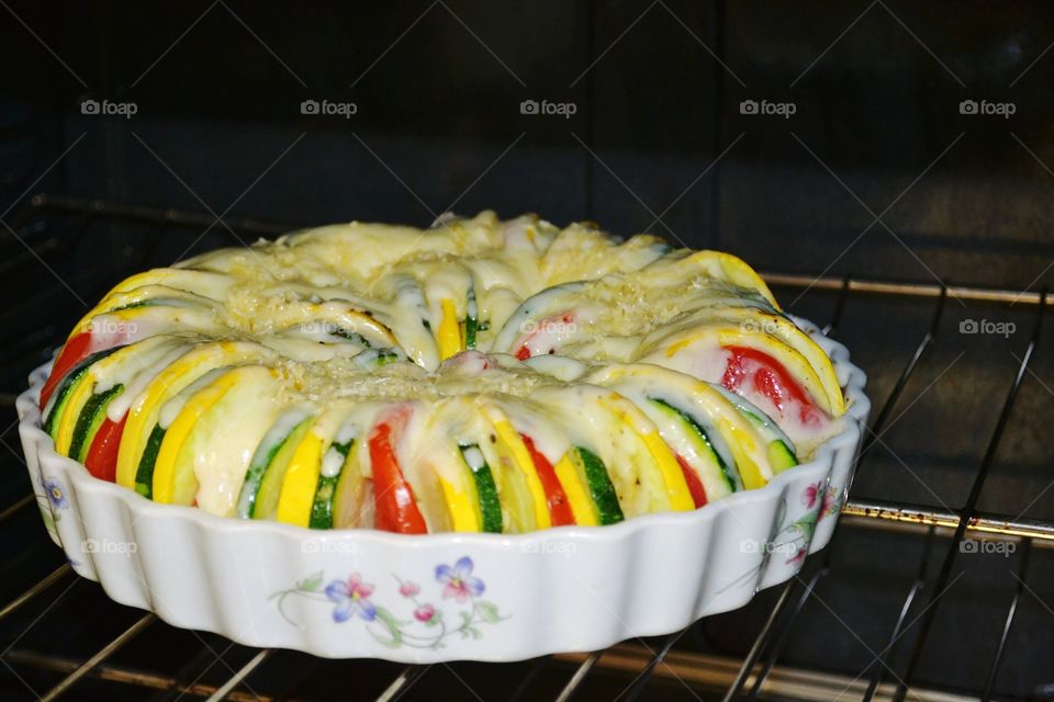 Cororful Vegetable Tian covered with Havarti cheese baking an oven
