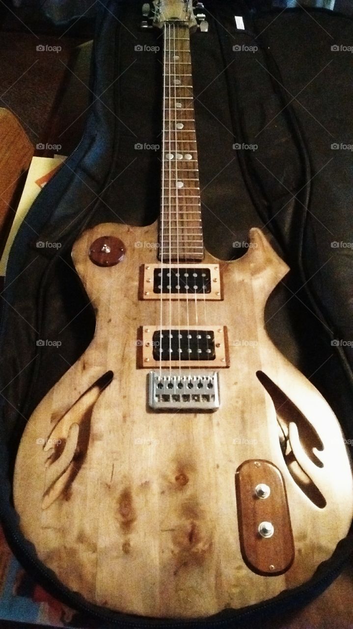 Custom built solid body electric guitar. Made with figured cherry and black walnut.