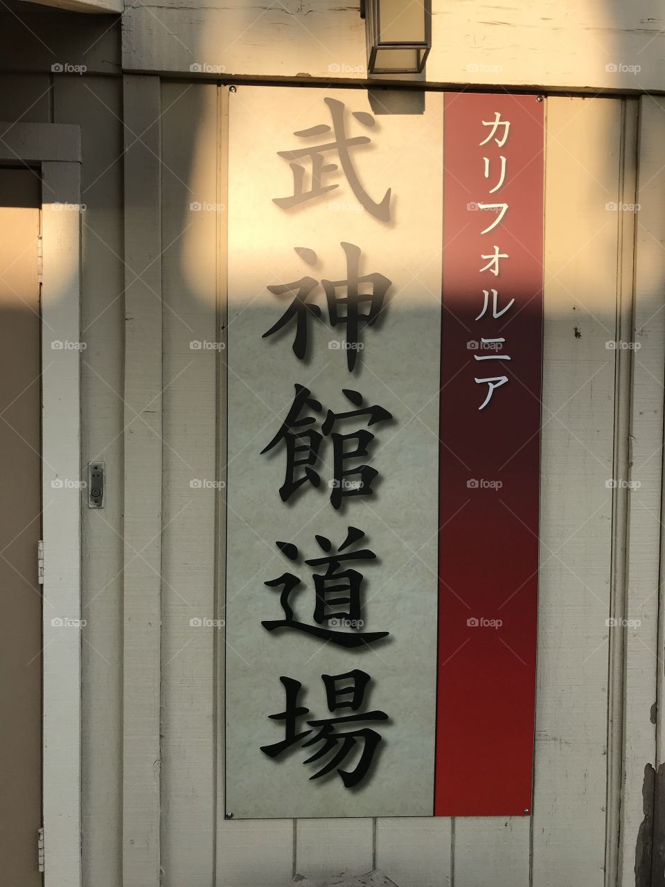 A Japanese martial arts dojo with an affixed sign of white and red. To enter this divine warrior training hall is to enter a Japanese cultural environment.